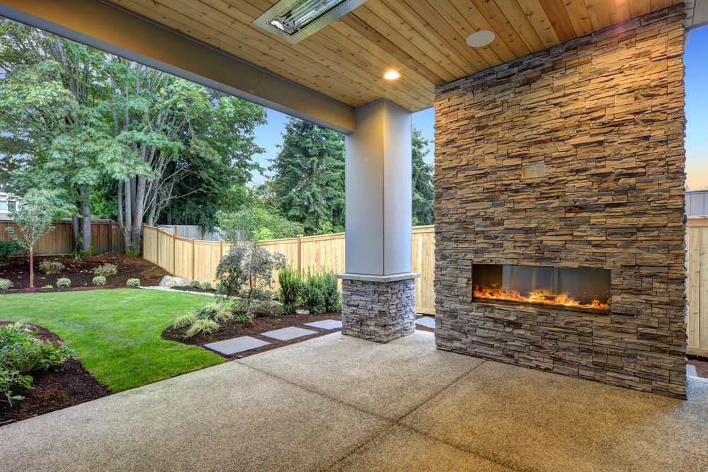 A natural patio with an outdoor fireplace