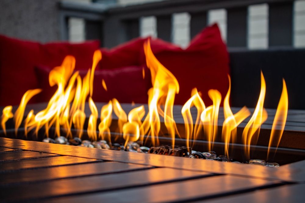 A closeup of the flames emanating from a metal fireplace